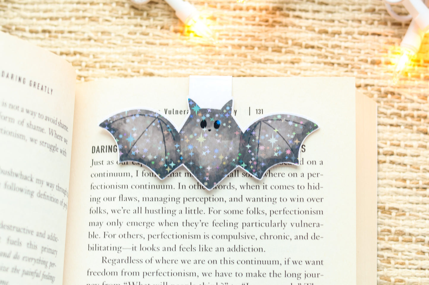 a book with a bat shaped brooch on it