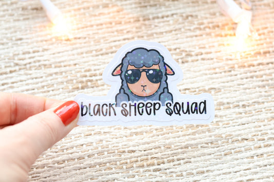 a hand holding a sticker that says black sheep squad