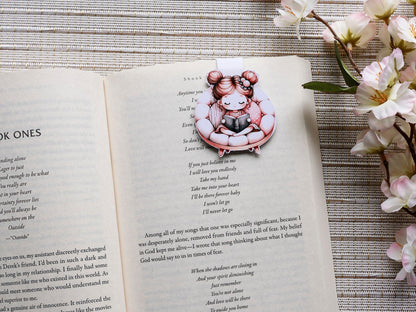 Magnetic bookmark of little girl with pigtails reading in pink papasan chair