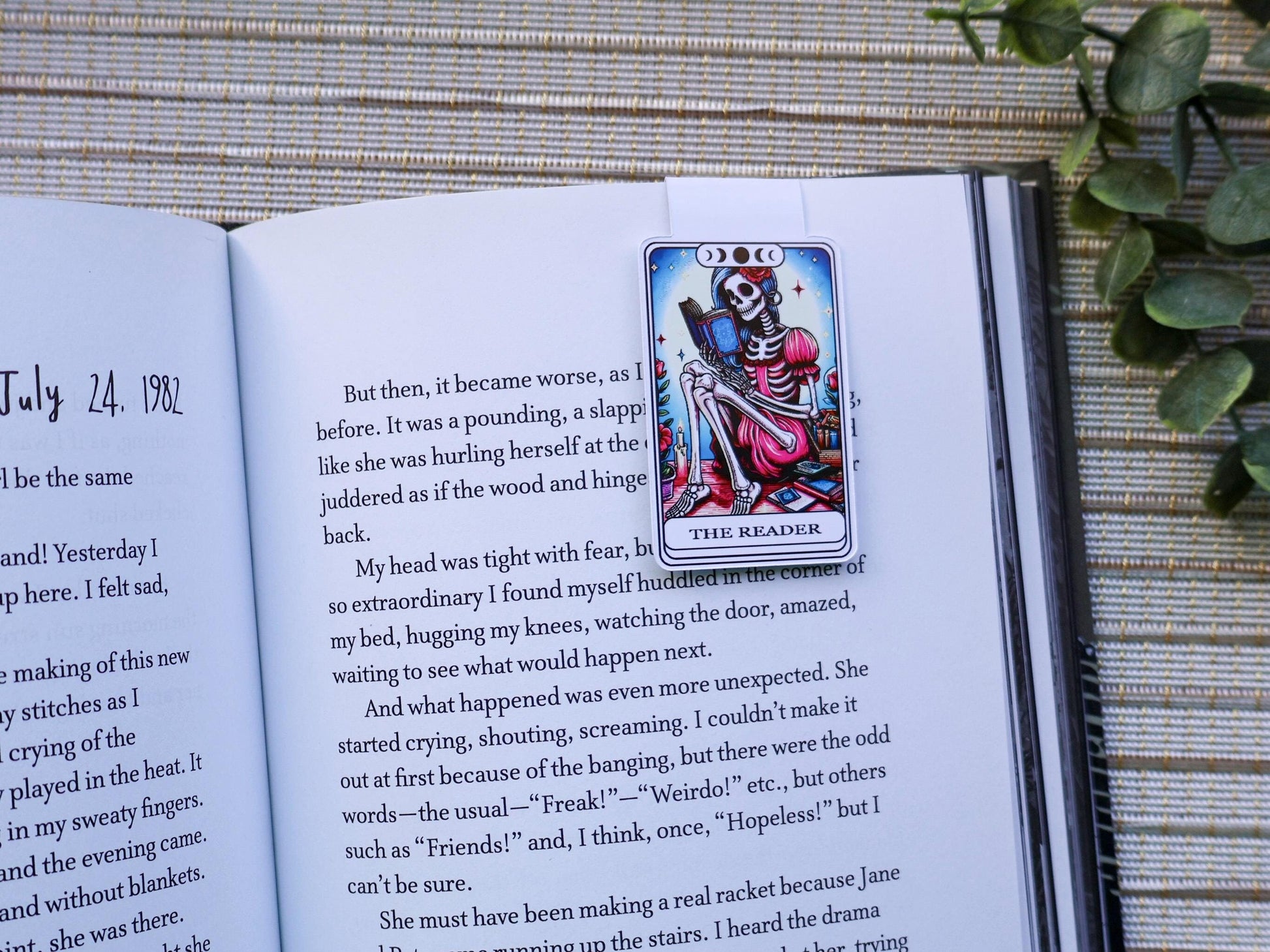 Magnetic bookmark featuring a tarot-card style &quot;The Reader&quot; with a skeleton woman reading a book